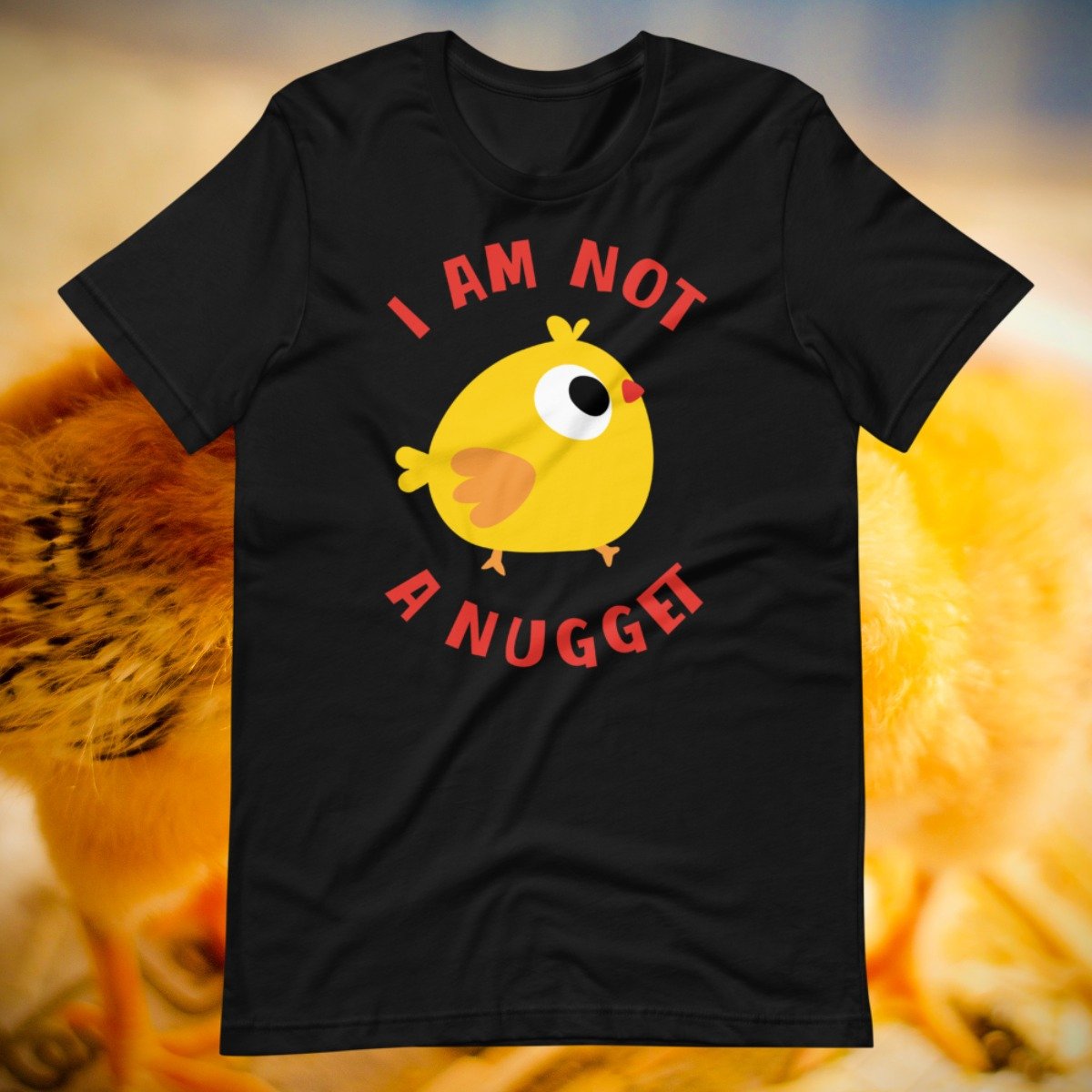 Vegan shirt with a baby chicken declaring they are not a nugget.jpg