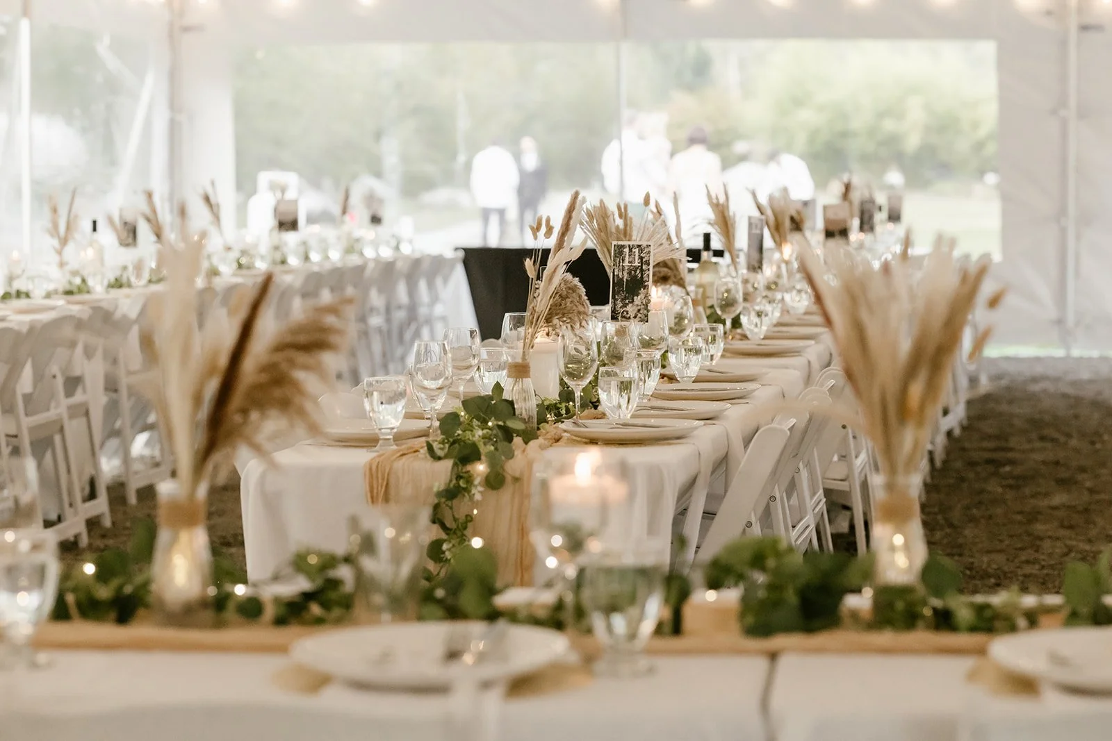  A wedding dinner reception setup with plates and flowers.  