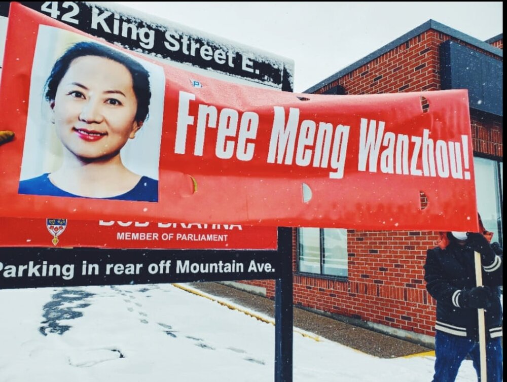 Featured image: A Free Meng Wanzhou sign.