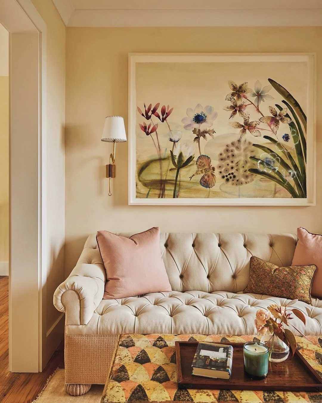 This seating area at our #LakeWaramaug project has been carved out of the upstairs landing. Decorated with a combination of floral artwork (&ldquo;Untitled&rdquo; by @lourdessanchez711) and an antique French trunk from Aero LTD, the space which funct