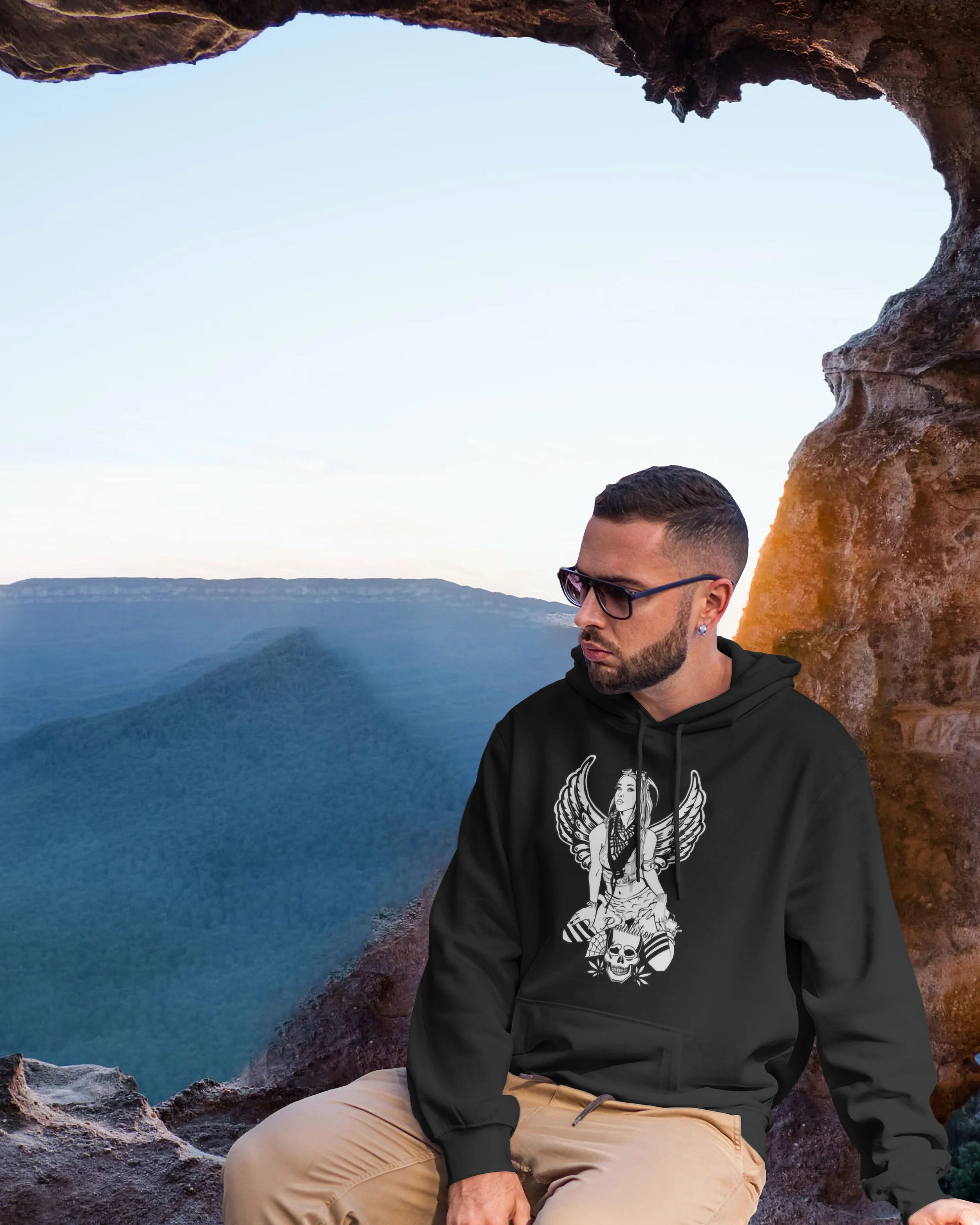 Guy wearing Fallen Angel Sweatshirt sitting in a Cliff JPEG.jpg