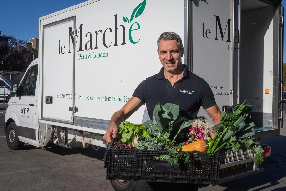Le Marché making a delivery with a plastic crate