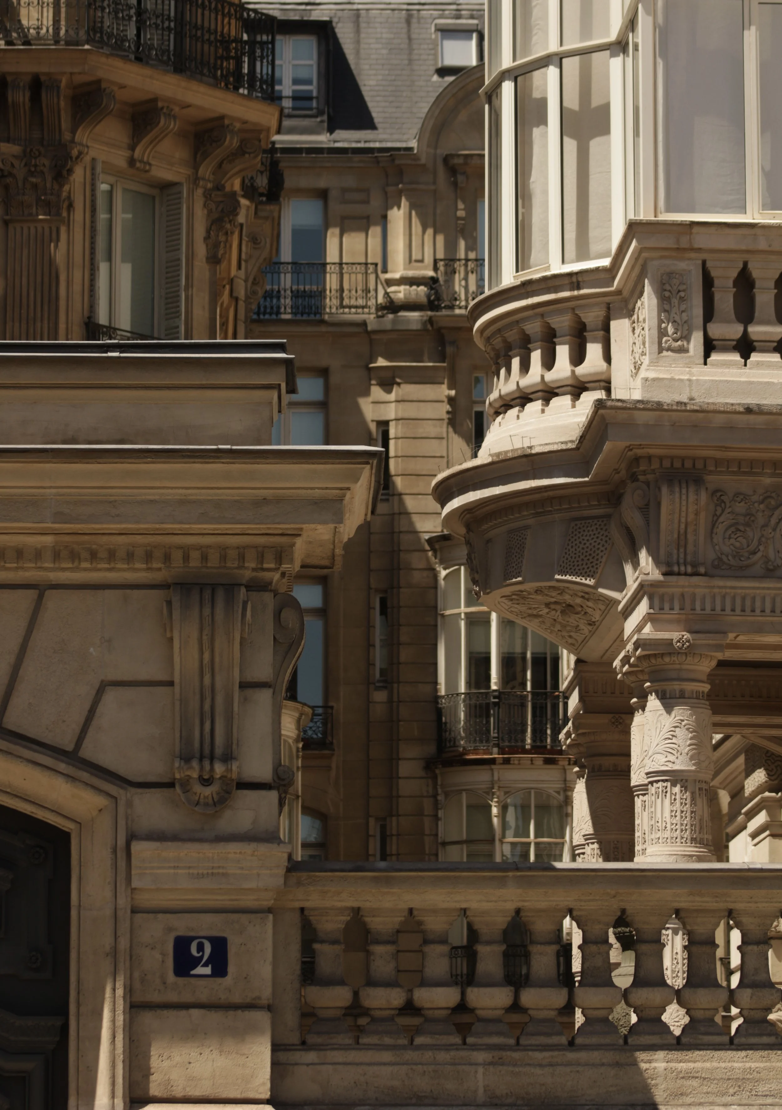 Close-up view of ornate stone balconies and architectural details on a historic building.