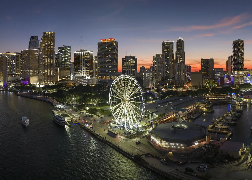 Night aerial view of the illuminated Downtown Miami skyline from a private airplane tour