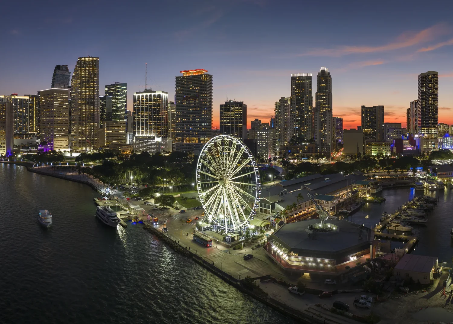 Night aerial view of the illuminated Downtown Miami skyline from a private airplane tour