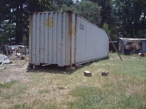 shipping container in a field used for extra storage space