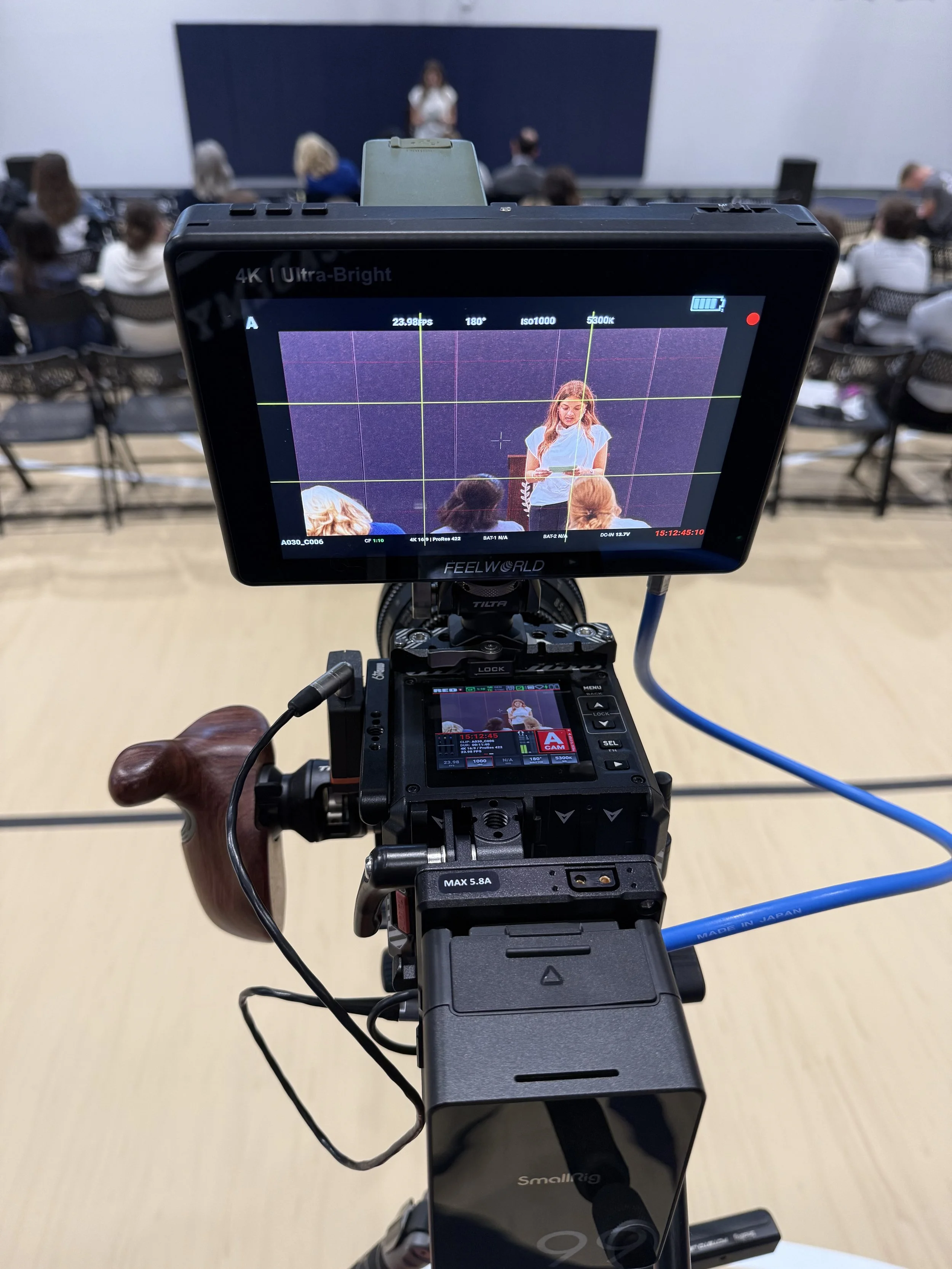 Professional video production filming a speaker during a corporate event in North Texas.
