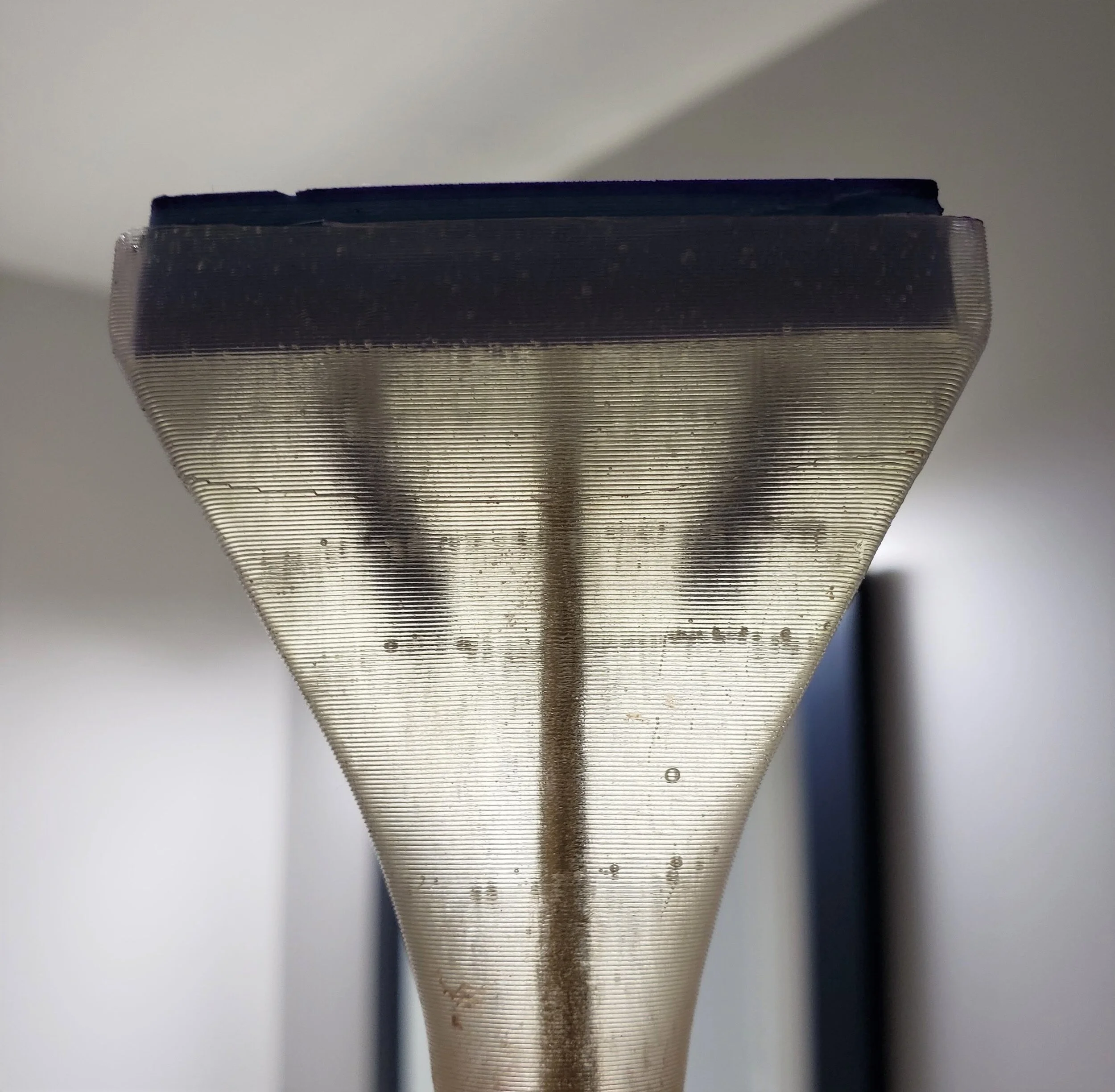 The solution I landed on for this was to drill two blind holes into the epoxy at the mating surface between the pad and the handle. Additional silicone was then poured into the holes and the pad was placed back in its slot to bond with the newly add