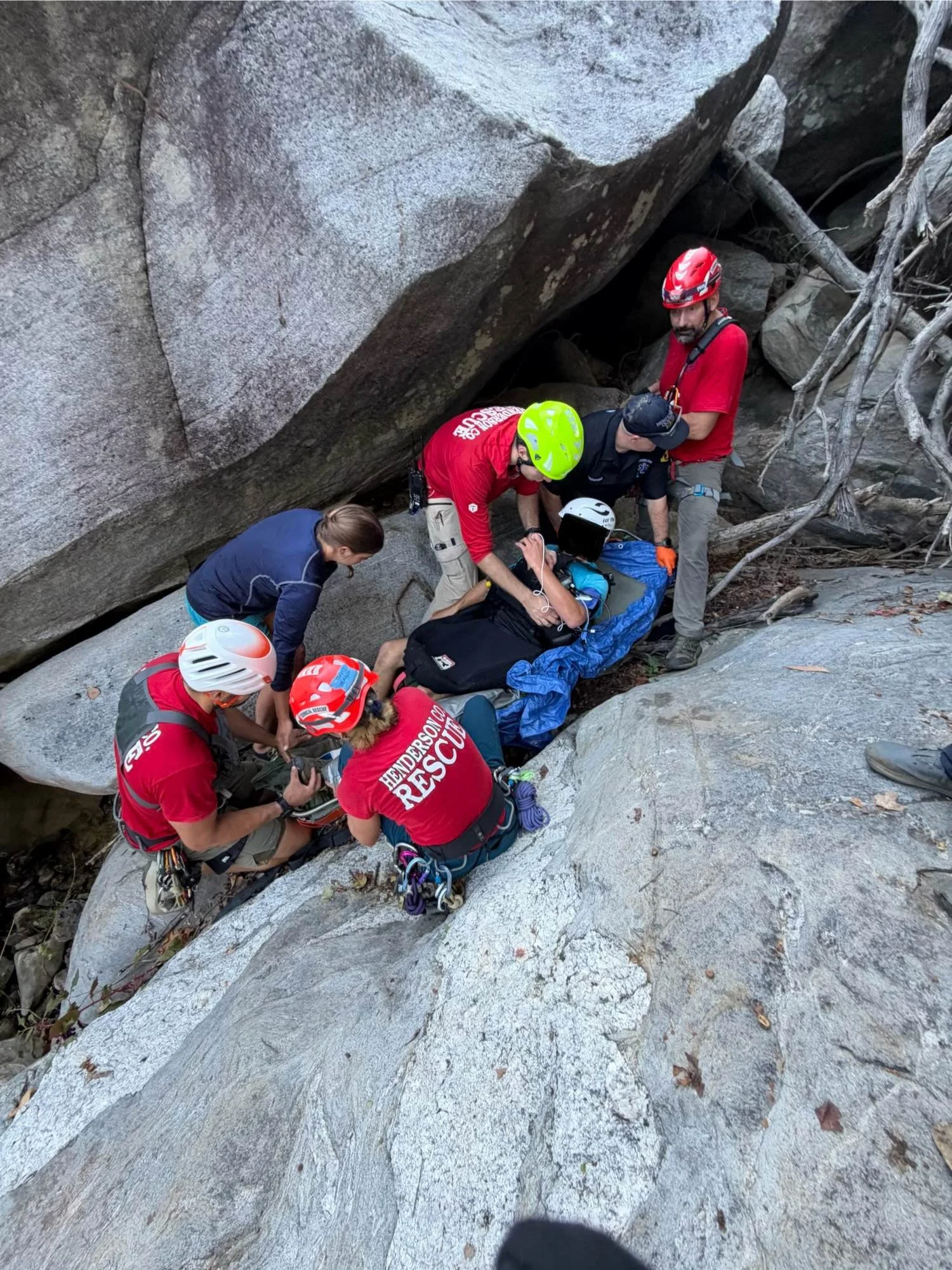Small technical rescue team packaging a patient in a litter among large granite boulders in North Carolina.