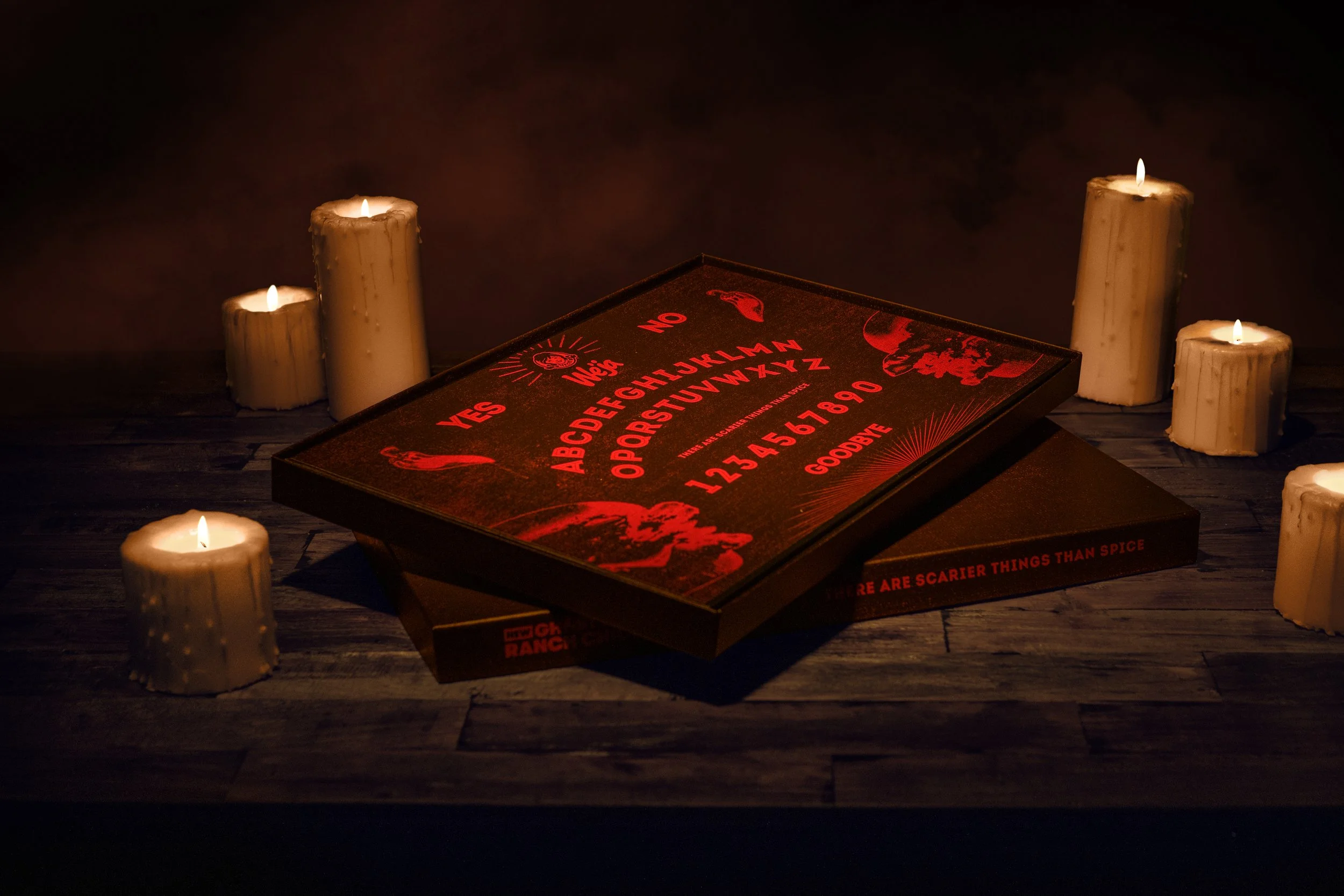 Weja Board in box surrounded by burning candles