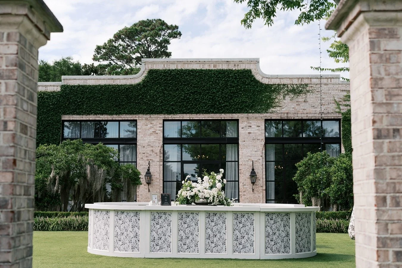 Echo Oval Bar 

Our 18-foot oval bar perfectly wrapping around the fountain at @wrightsvillemanornc for a showstopping focal point. 

For an extra touch of personality, we customized the front panels with bold black and white floral wallpaper &mdash;