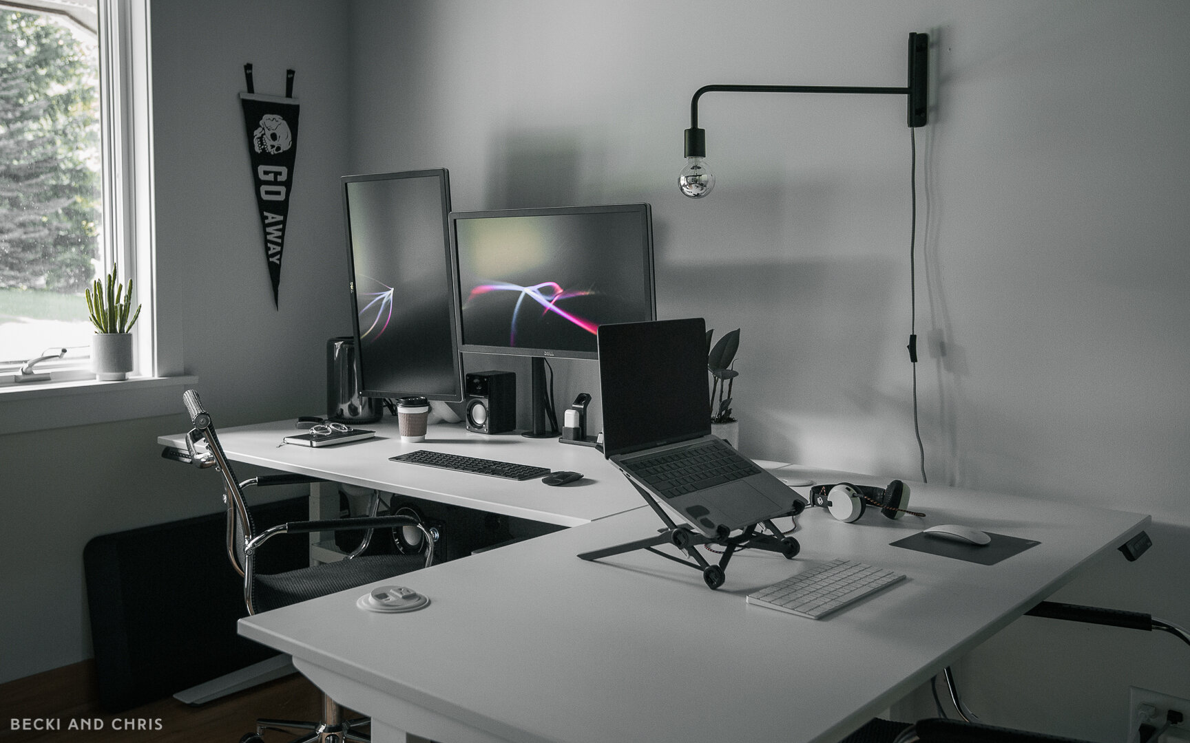  We used two standing desks placed in an L shape to separate our workspaces. We decided to go with two desks instead of one l-shaped desk to give us the option of reconfiguring the space, and flexibility if we ever move these to a different space. 