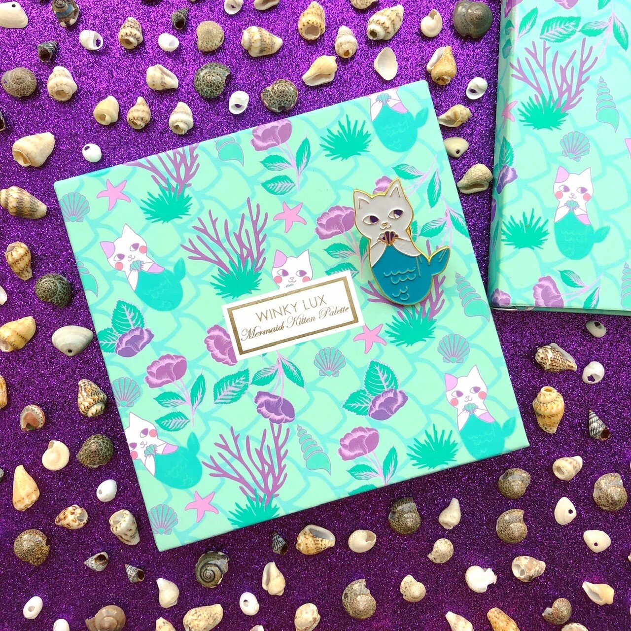   Mermaid Kitten Palette Winky Lux  Fall 2018   Winky Lux expands the merfolk universe to include felines by incorporating the brand’s signature kittens. The ad copy highlights the fantastical combination of cats and fish and the transformative abili