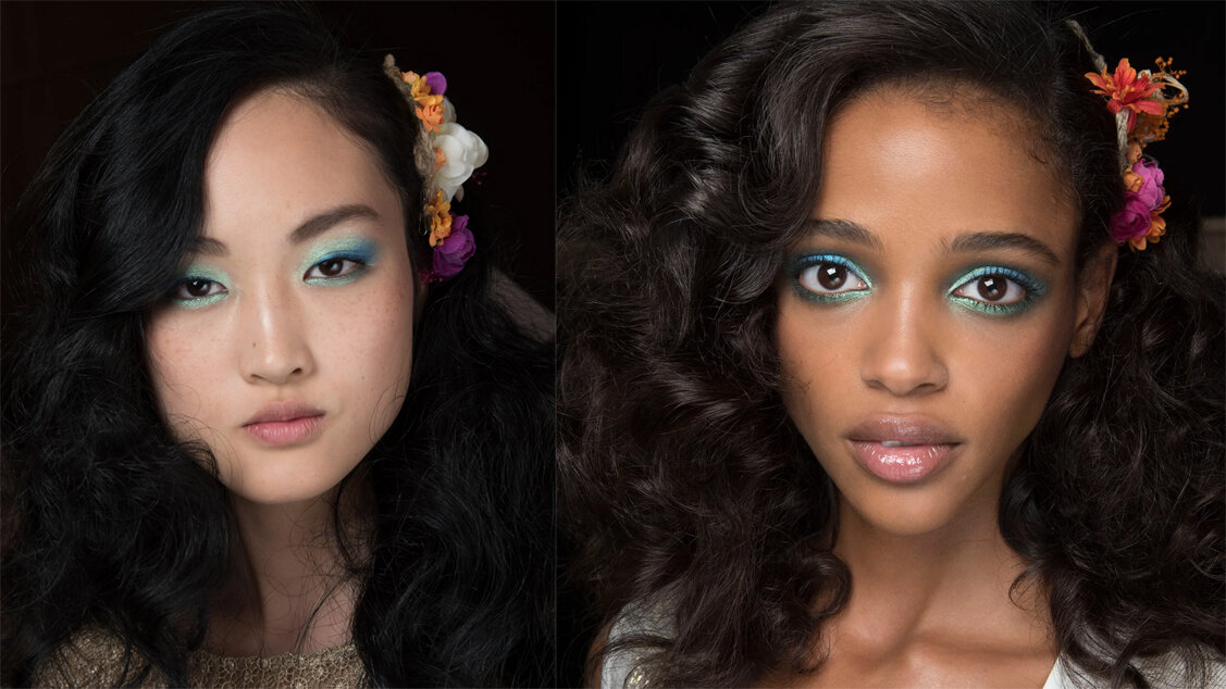   Diane Von Furstenburg Spring 2016 Models: Jing Wen and Aya Jones Photos:    Makeup artist Pat McGrath created an aquatic-inspired look with shimmery blue and green eyeshadow. Brightly colored flowers in the models’ wavy styled hair added a subtle n