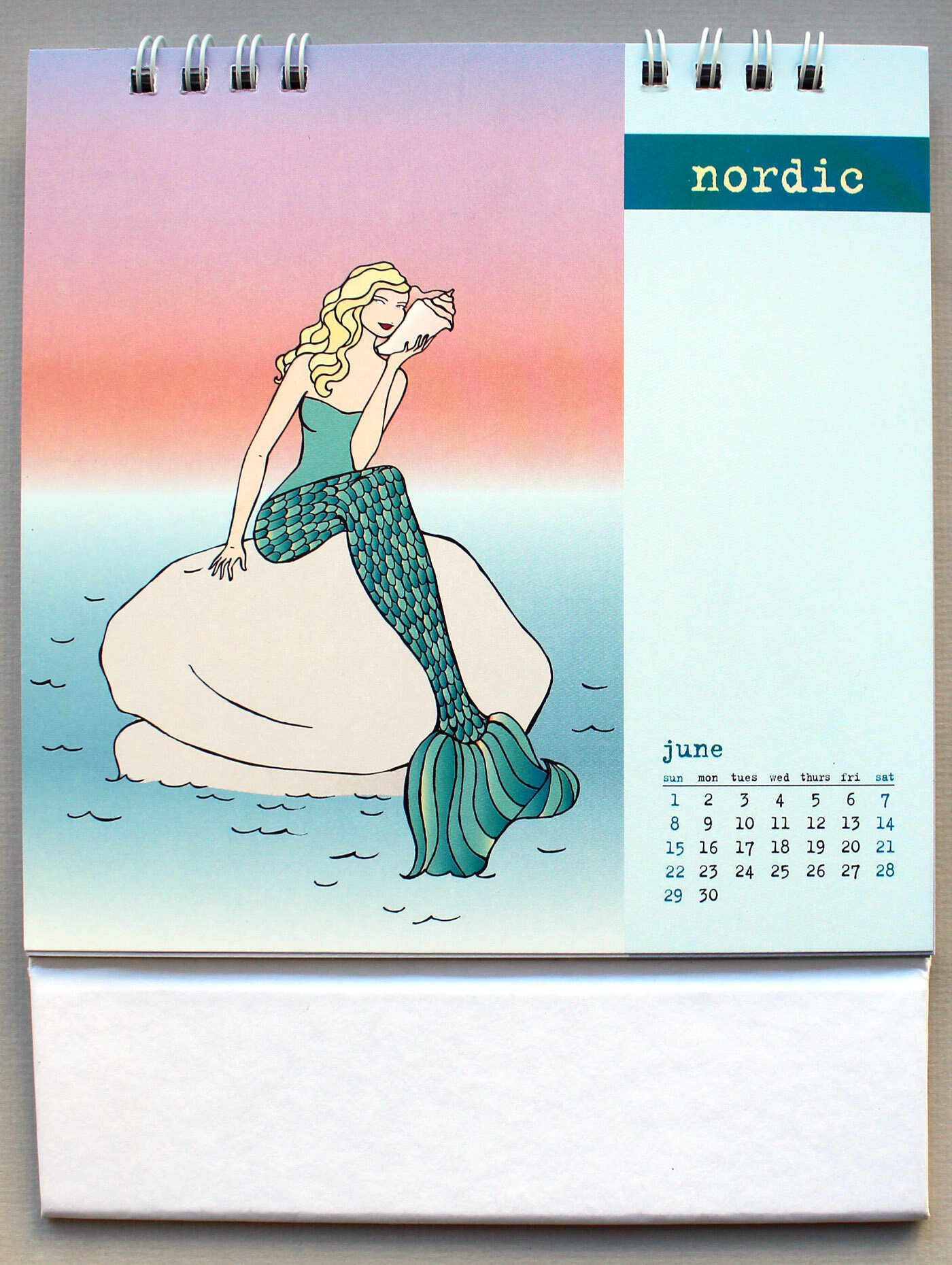   Calendar Stila 2003   Stila provided their employees with an illustrated calendar that featured one of their signature girls visiting a different city each month. For the month of June, Stila transformed one of the girls into a mermaid. It is belie