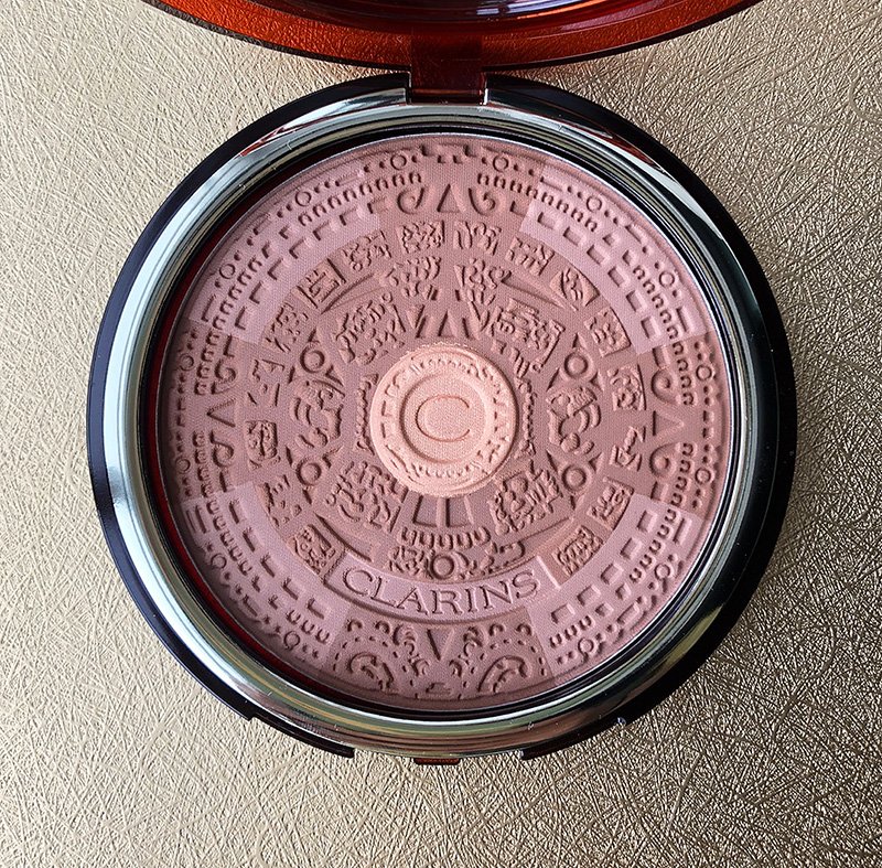   Splendours Bronzing Compact Clarins, Summer 2013   “Sunshine into gold. Travel to faraway lands, to the heart of an ancient people…and discover the splendours of a pre-Columbian civilization that worshiped the sun.” While the ad copy for Clarins’ S