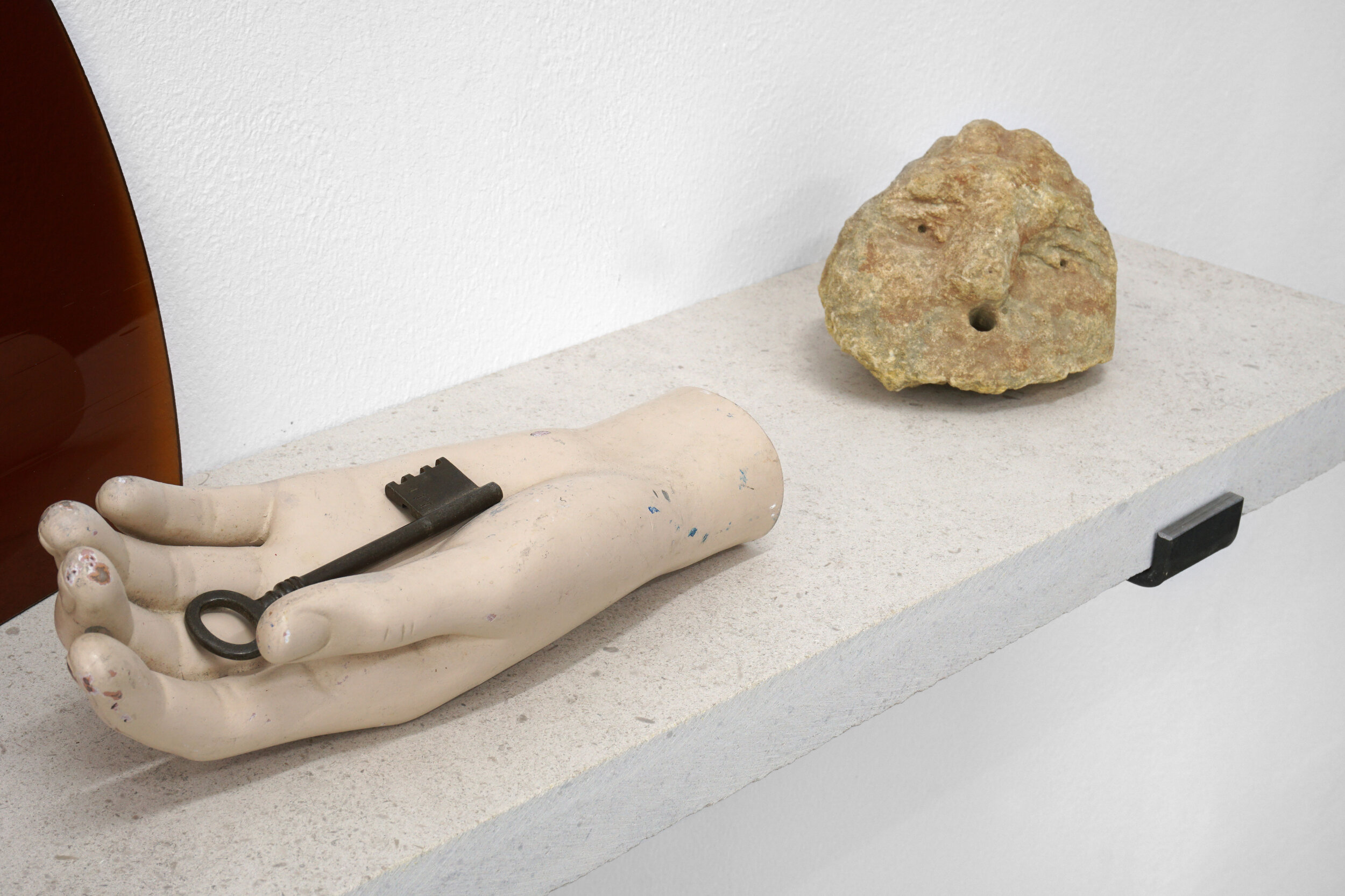   Within the reach of a grasping hand , 2019, various found objects, limestone, glass, steel, 51.5x120x20cm 