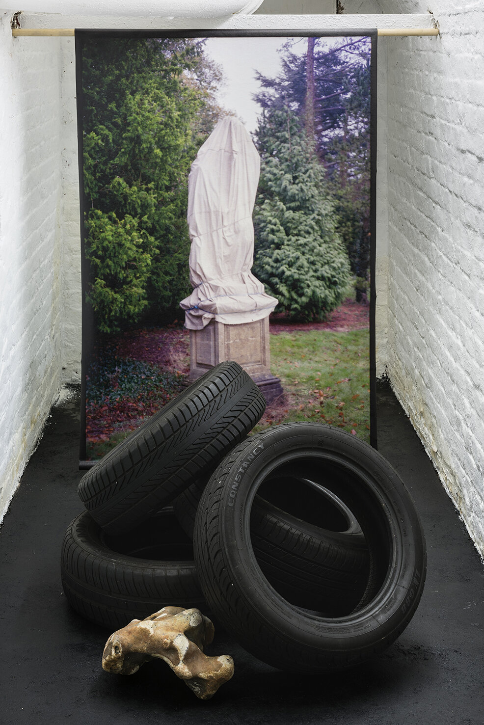   Constancy , 150x100cm inkjet print on canvas, used car tyres, and flint rock from Seaford Head, Variable Dimensions 