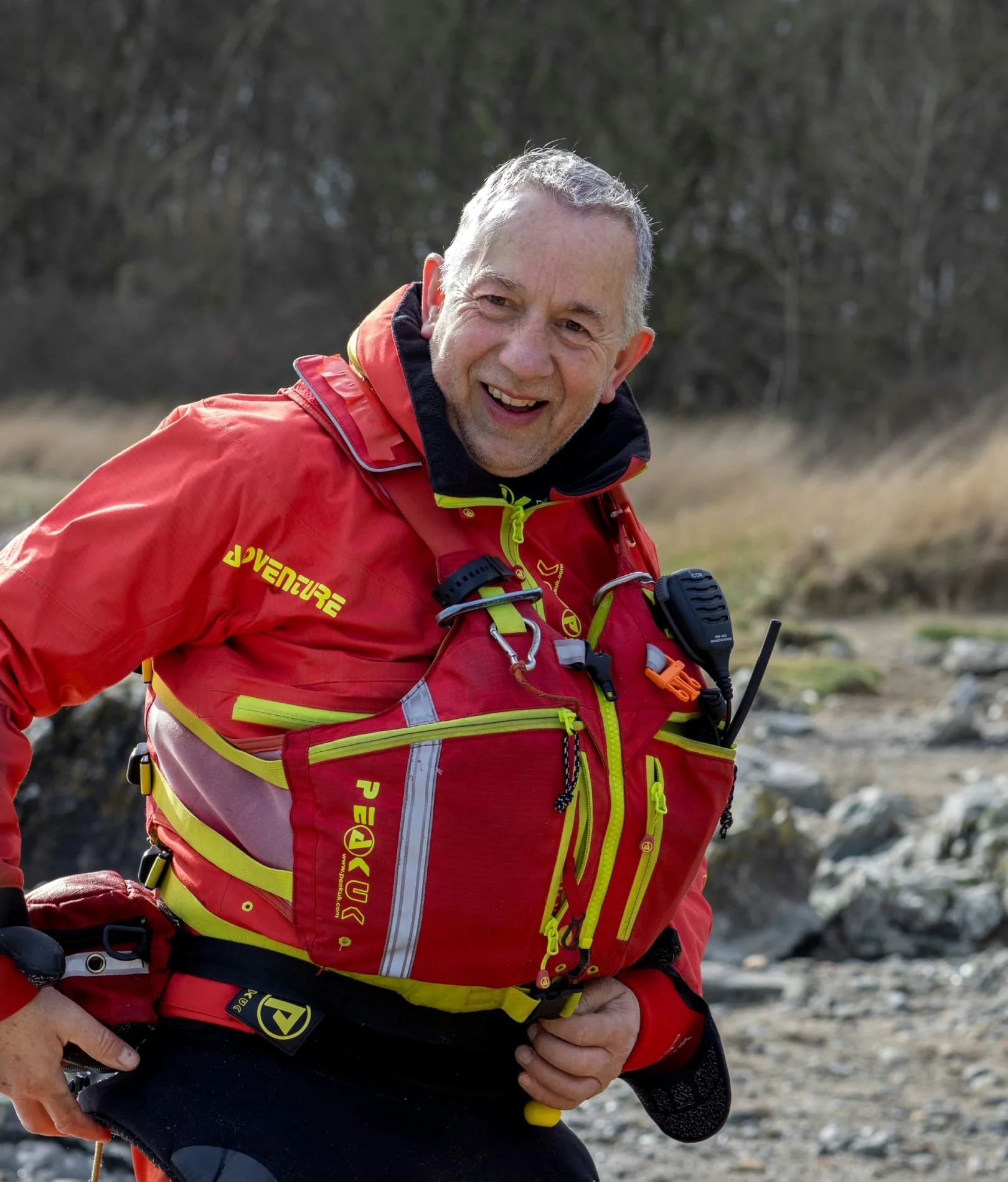 Kayaker in red kayaking equipment buoyancy aid & cag 