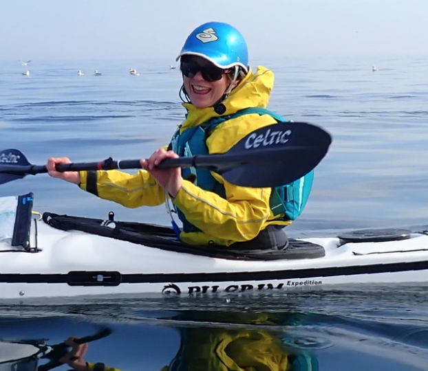 1 woman blue helmet white boat kayaking for sea kayaking wales