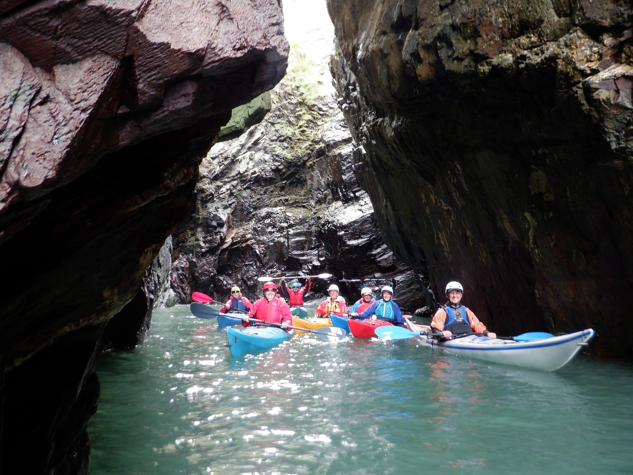 Sea kayaking coaching for beginners practising boat handling skills on sheltered water