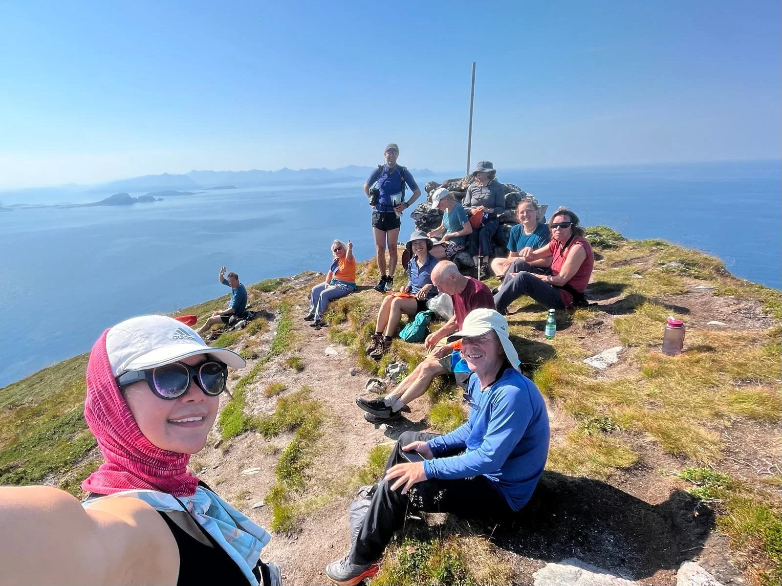 Sea kayaking expedition team on the summit of Håja Island above the Tromsø archipelagos in Arctic Norway