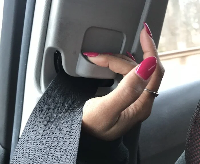 Pressing the button helped me lower the seatbelt height with ease.
