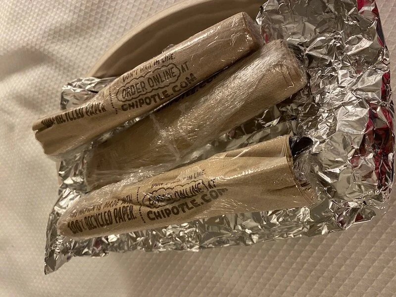 Picture of Chipotle plasticware wrapped in plastic wrap.