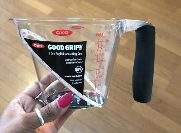 Picture of my brother’s clear, plastic measuring cup (from the side).