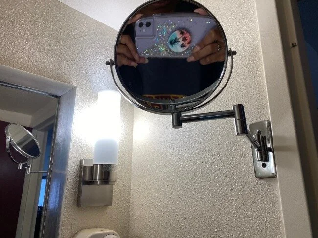 Image of magnifying side of the two-sided mirror showing a distorted reflection from my height.