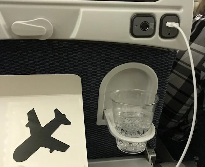 Image of the cup holder that created more space, making my airplane tray table easier to use.