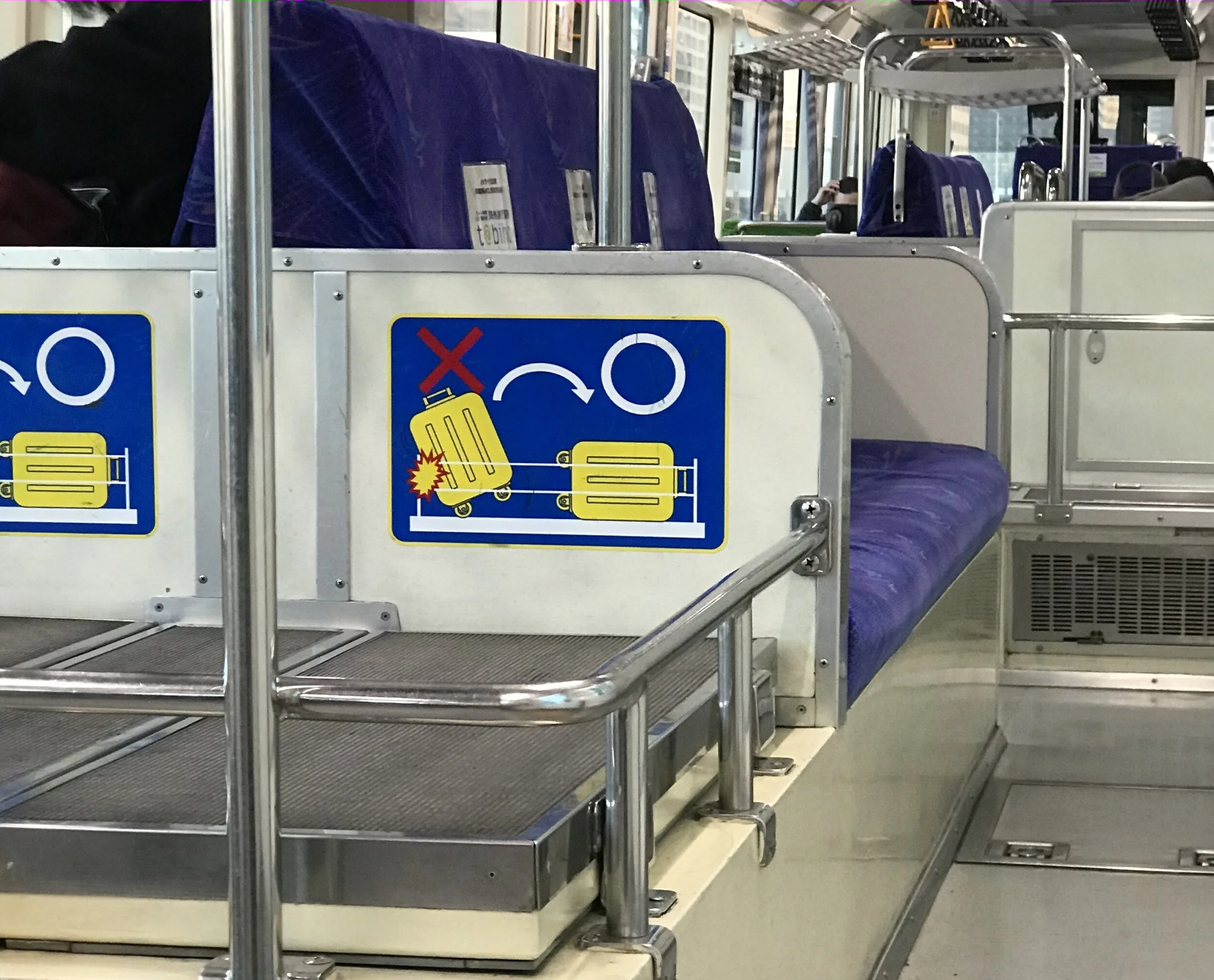 Close up image of the sign giving guidance on correct luggage storage when using the storage area on the train.