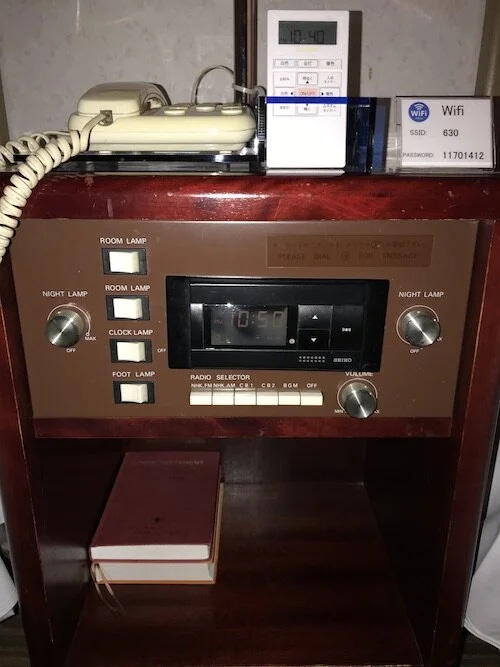 Image of another lighting control panel combined with a radio on a nightstand near the bed in a different hotel room.