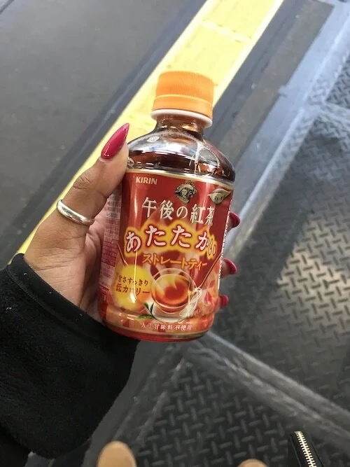 Image of me holding a bottle of hot tea.