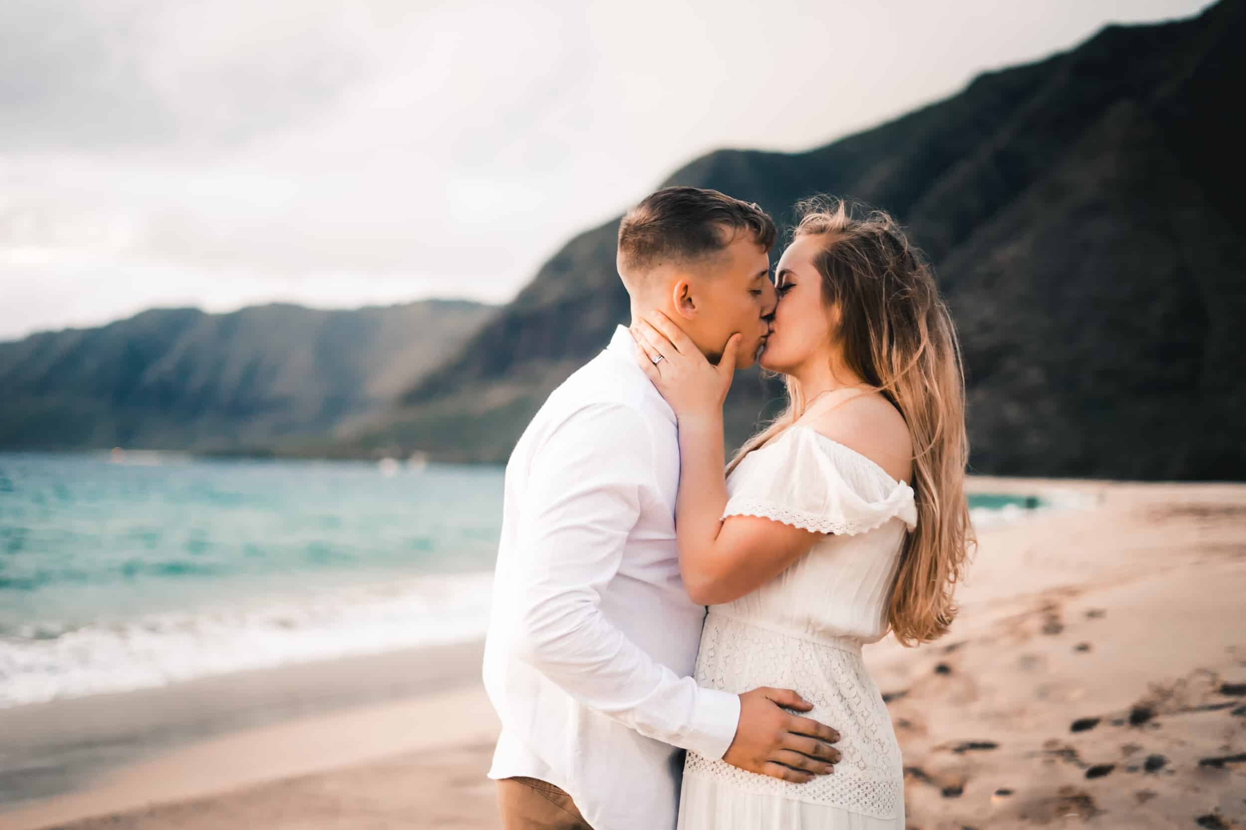 Hawaii kissing couple beach wedding