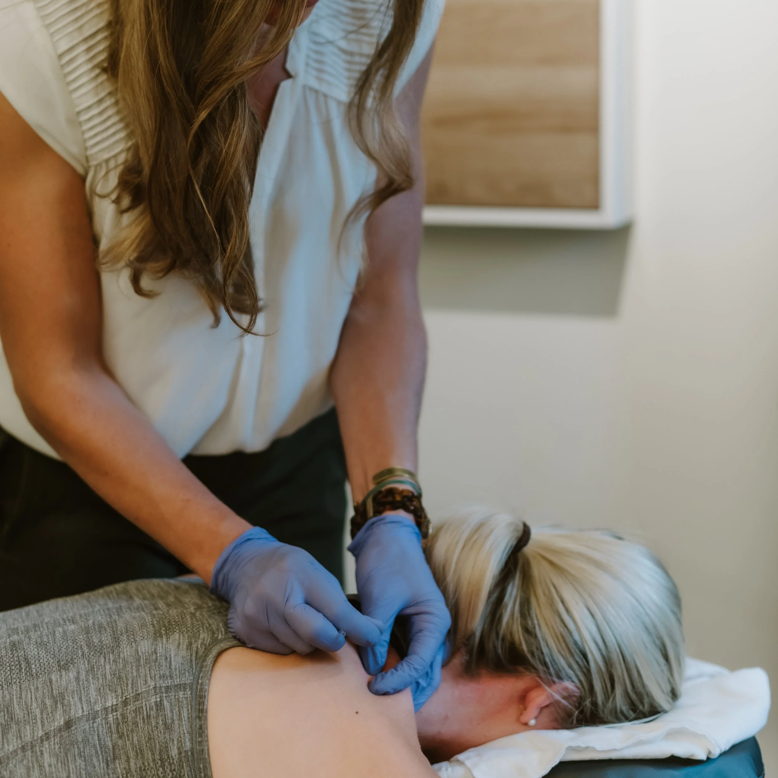 Physical therapist performing dry needling to treat painful neck.