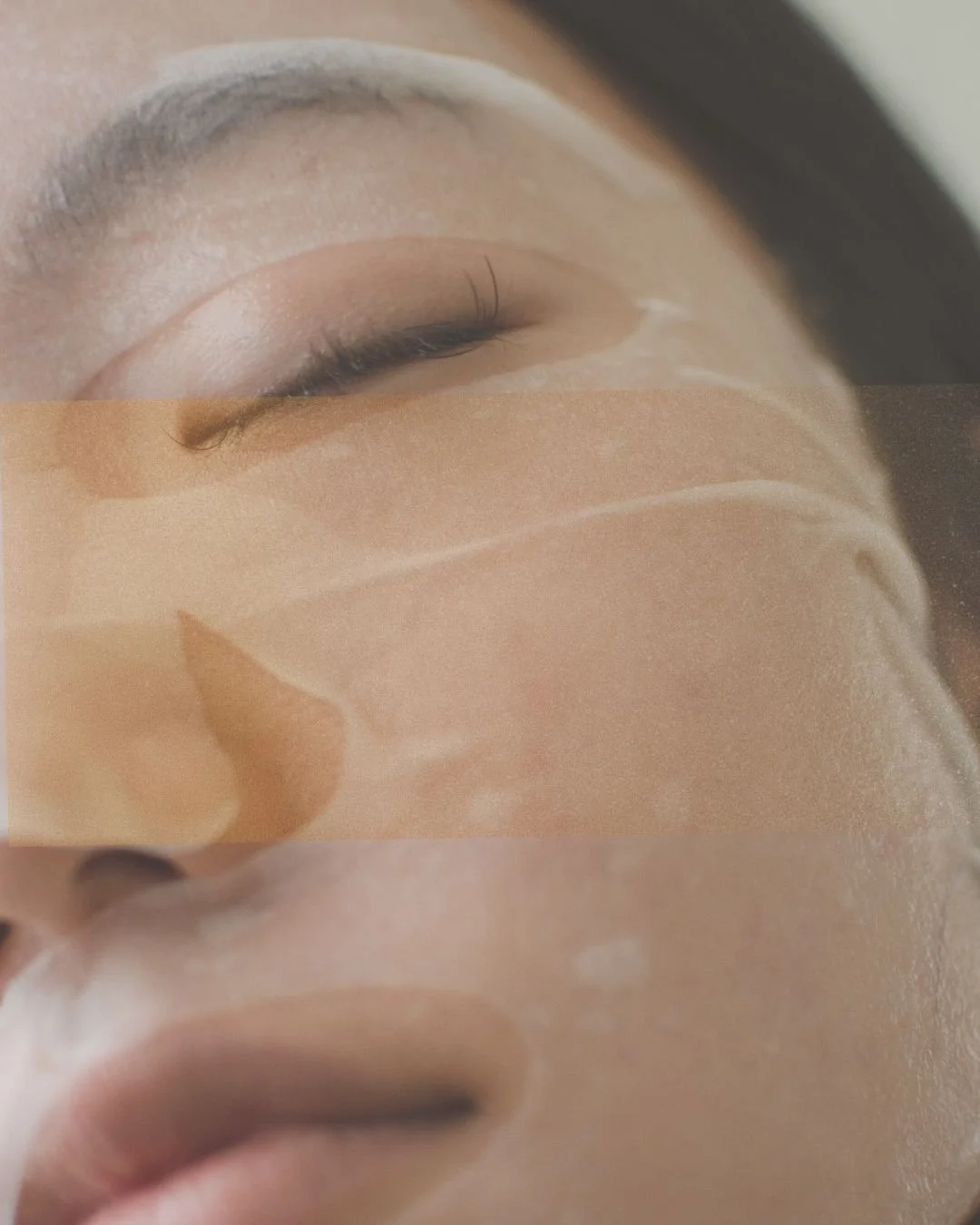 Close-up image of a person with a facial sheet mask, focusing on their closed eye and nose, showing a skincare routine.