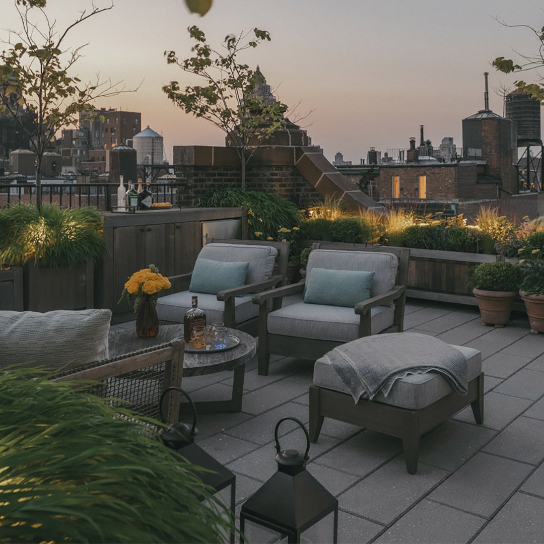 Swipe to see the before.

This penthouse terrace was reimagined as a calm, inviting retreat designed for relaxing and entertaining. A bespoke teak bar cabinet, complete with generous storage and an integrated fridge, forms the heart of the space, whi