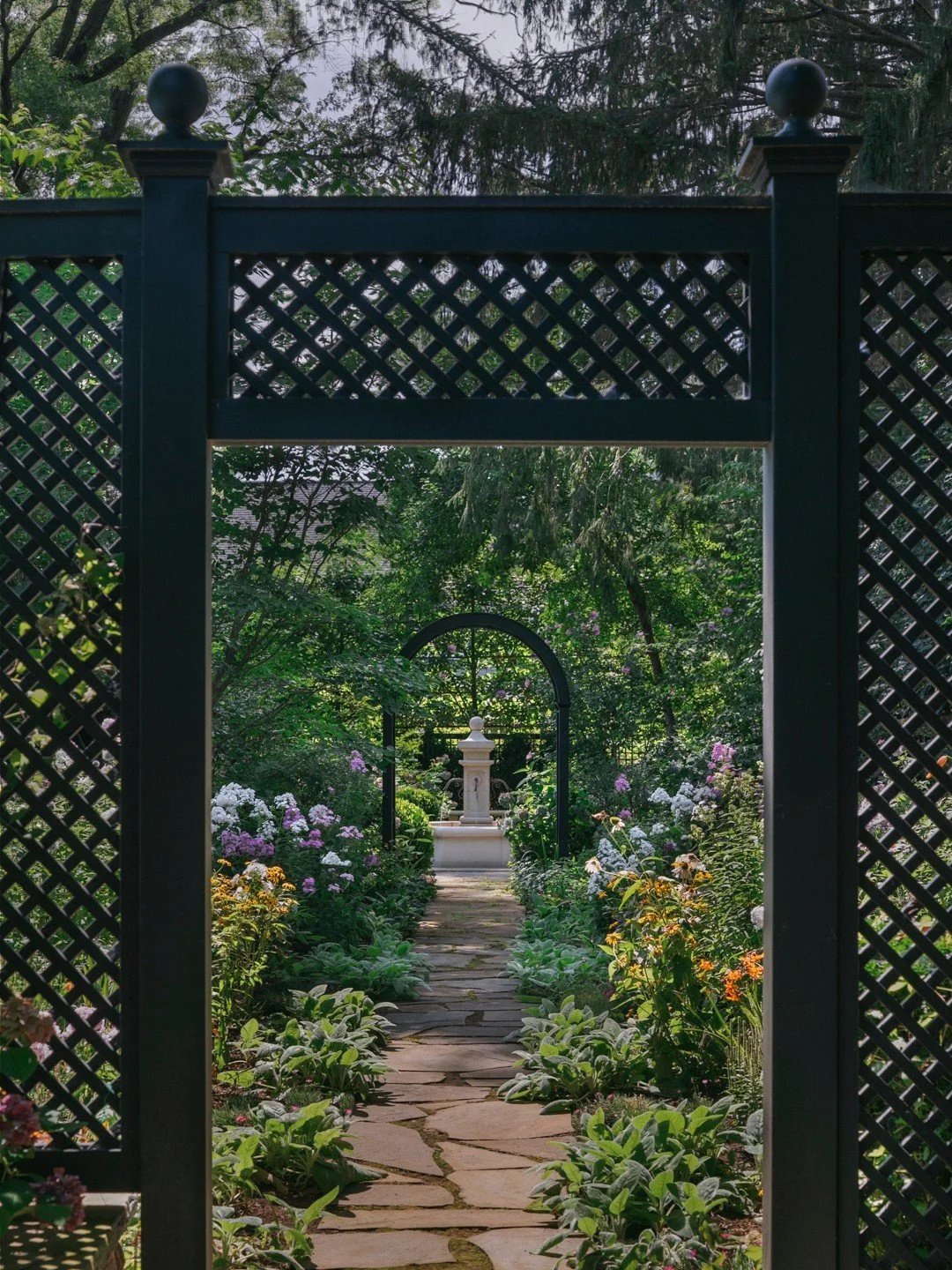 DEA-designed archways lead through the perennial garden towards a bespoke stone fountain, carefully specified by DEA and handcrafted in France.

#LandscapeArchitecture #LandscapeDesign #GardenDesign #PlantingDesign #PerennialGarden #GardenDetails #Be
