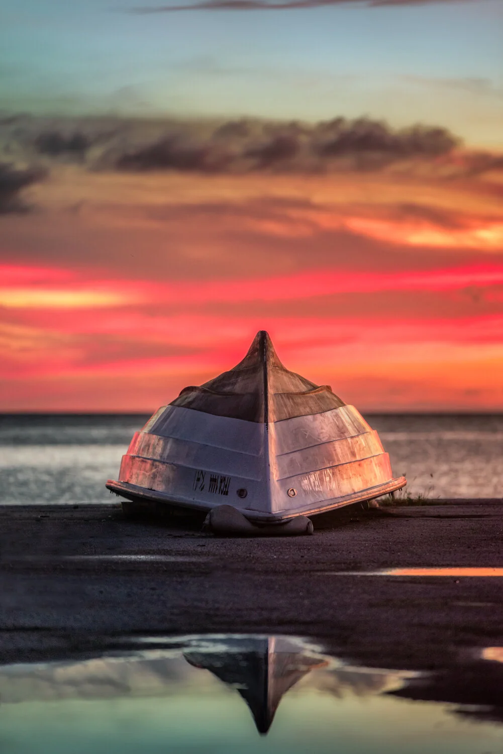 "Inversion" 2020. An overturned boat under the sunset sky in Brickfield fishing village.
