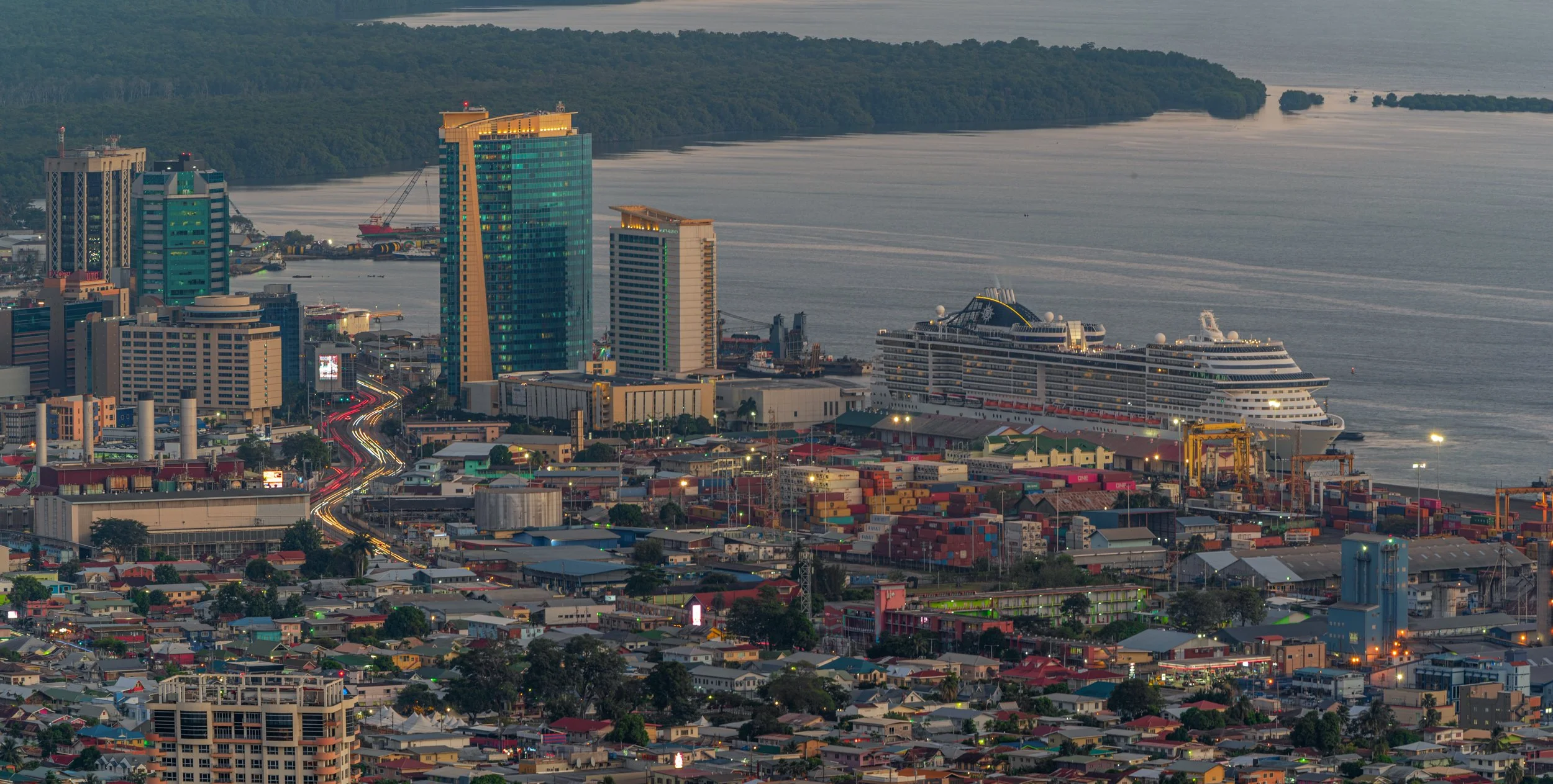 "A visual chronicle: Port of Spain waterfront cityscape at dusk", January 23, 2020
Today's image vividly captures a unique moment in Trinidad and Tobago's history, showcasing the confluence of industrial heritage and modern travel. The panoramic view