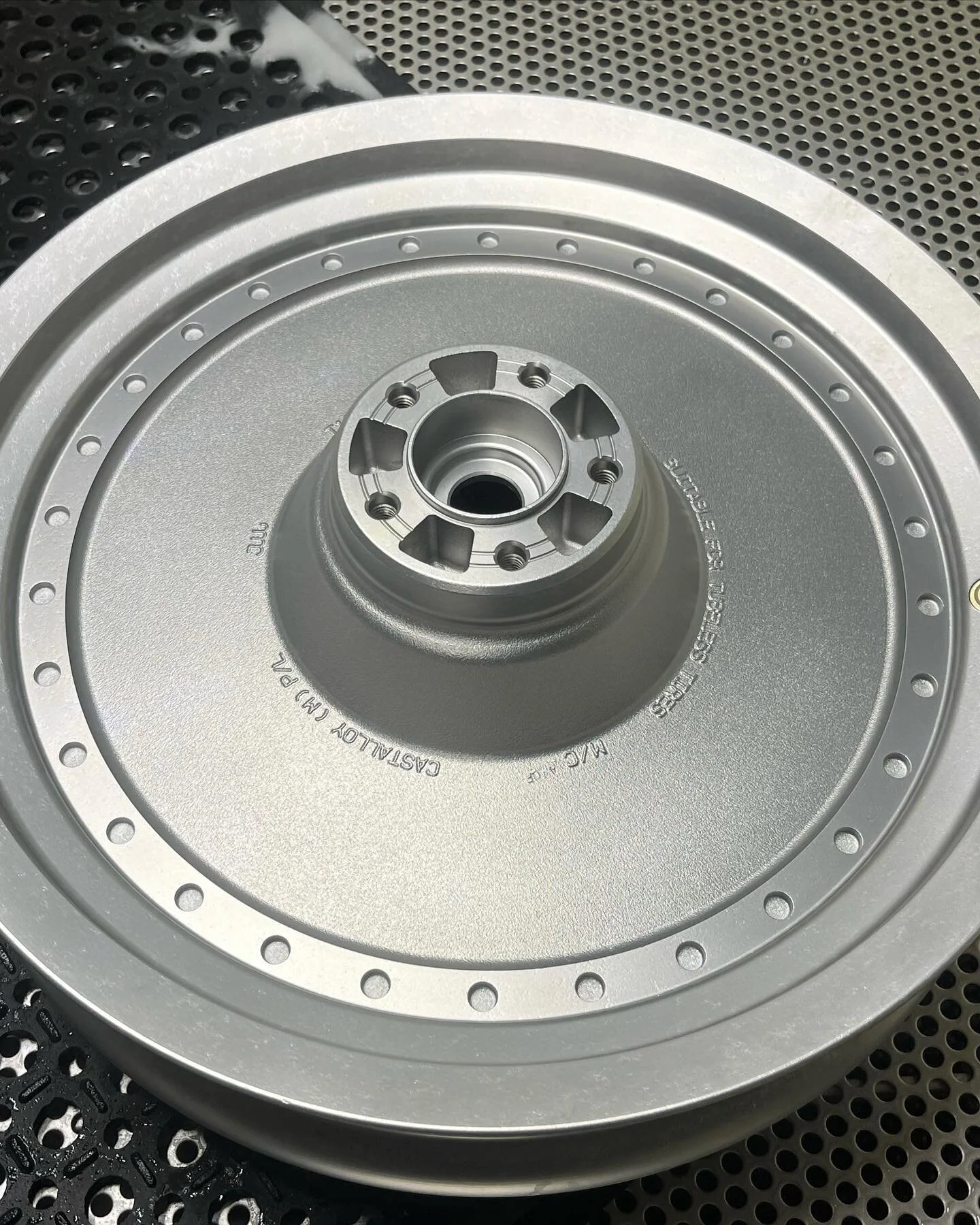 Harley Davidson rim vapour blasted in preparation for machining/milling of the non-textured outer sections of the rim.