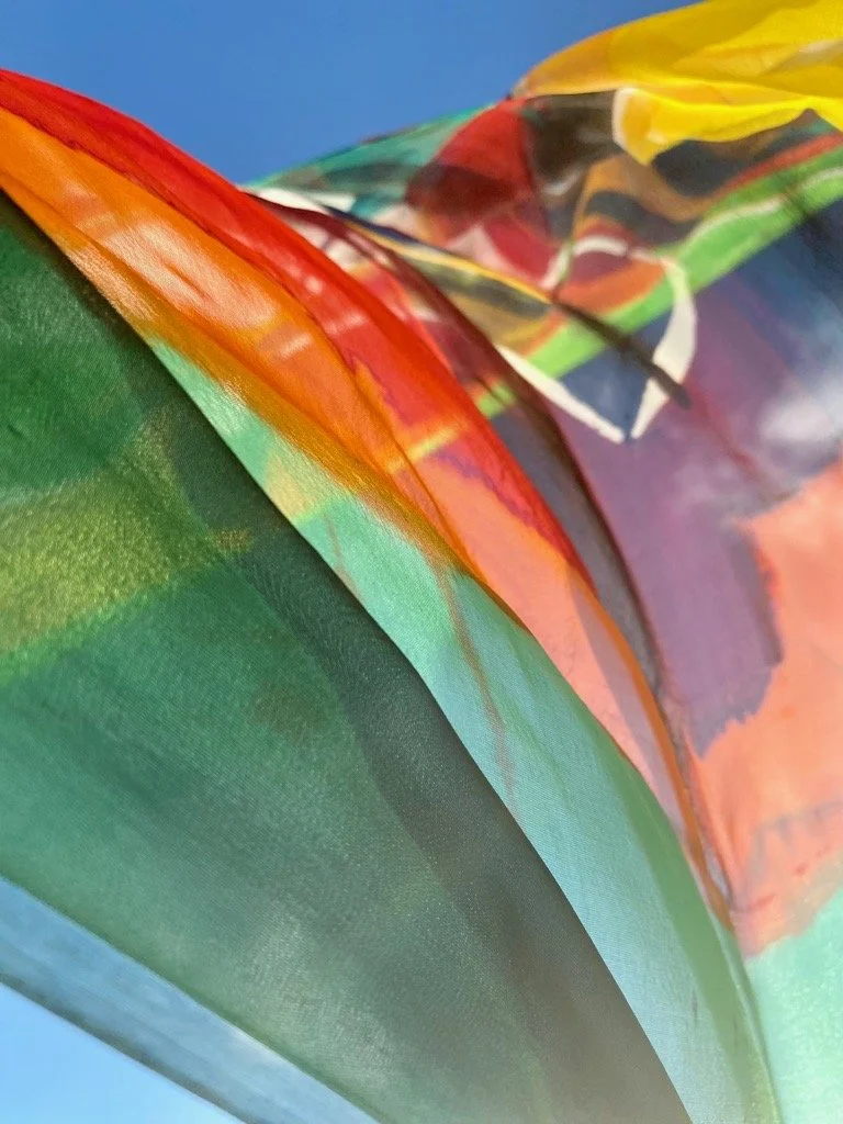 Close-up of colorful plastic or fabric material with green, orange, red, yellow, and black sections.