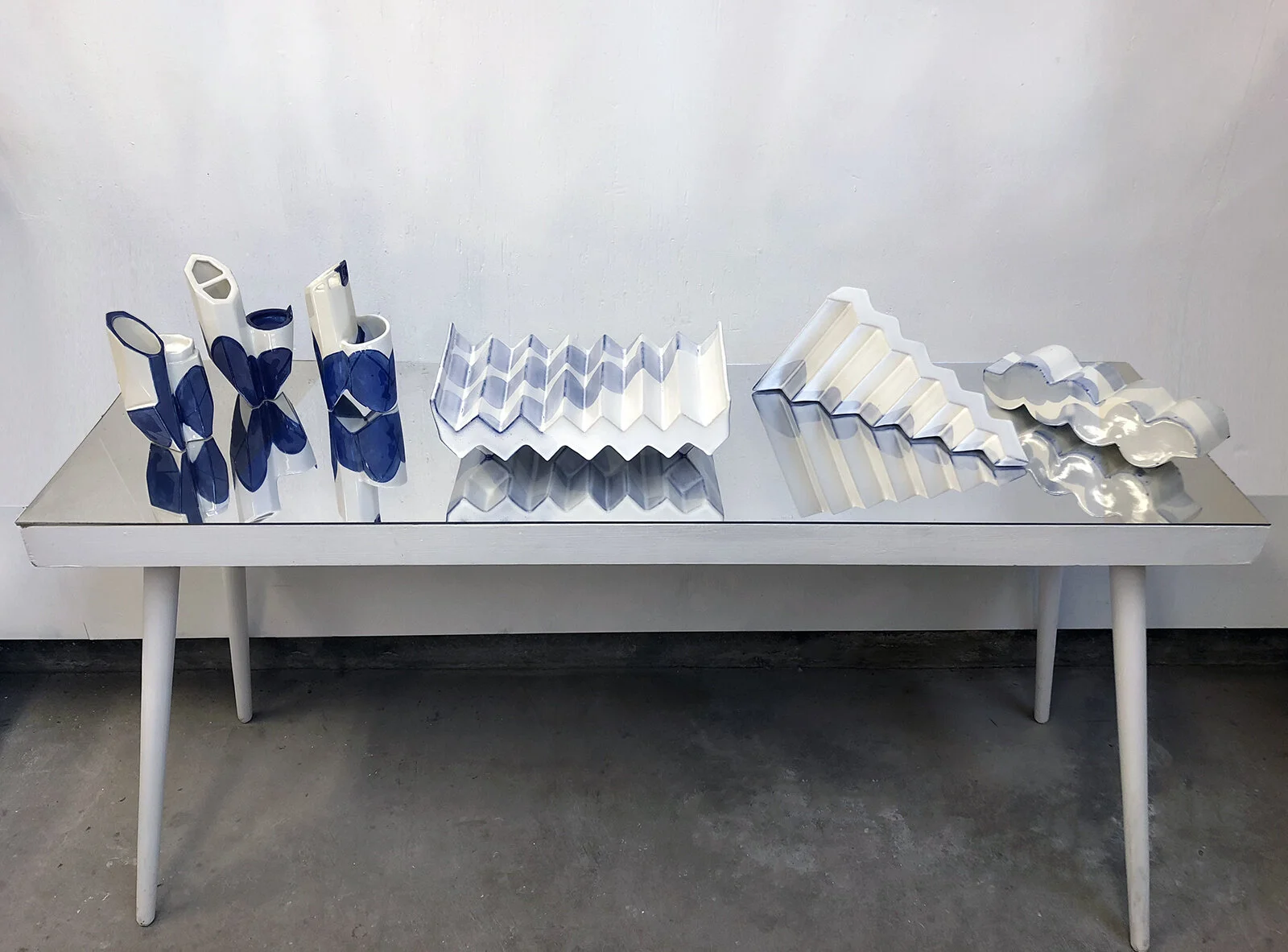   New Garntitures (2), 2017    Porcelain, underglaze, mirror, found table.    