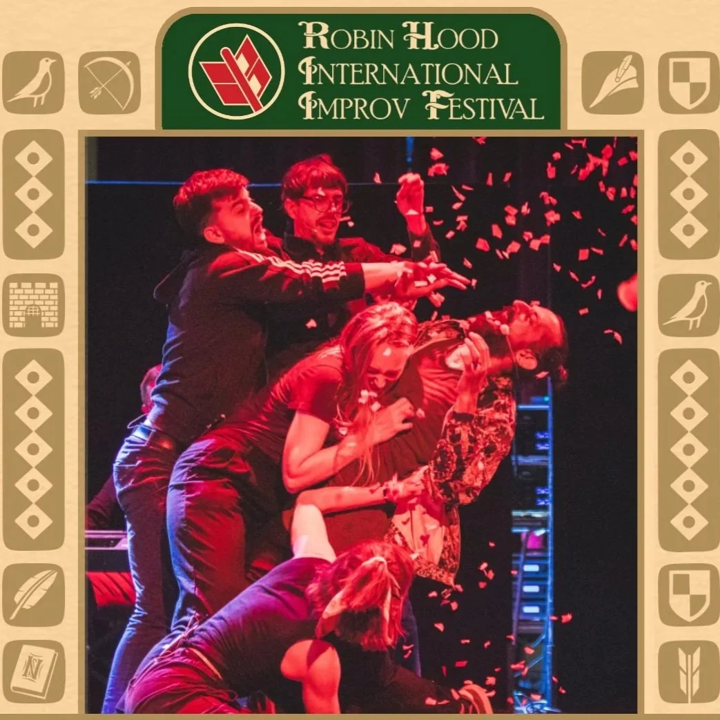 A picture of improvisers bathed in red light with confetti being sprinkled over them