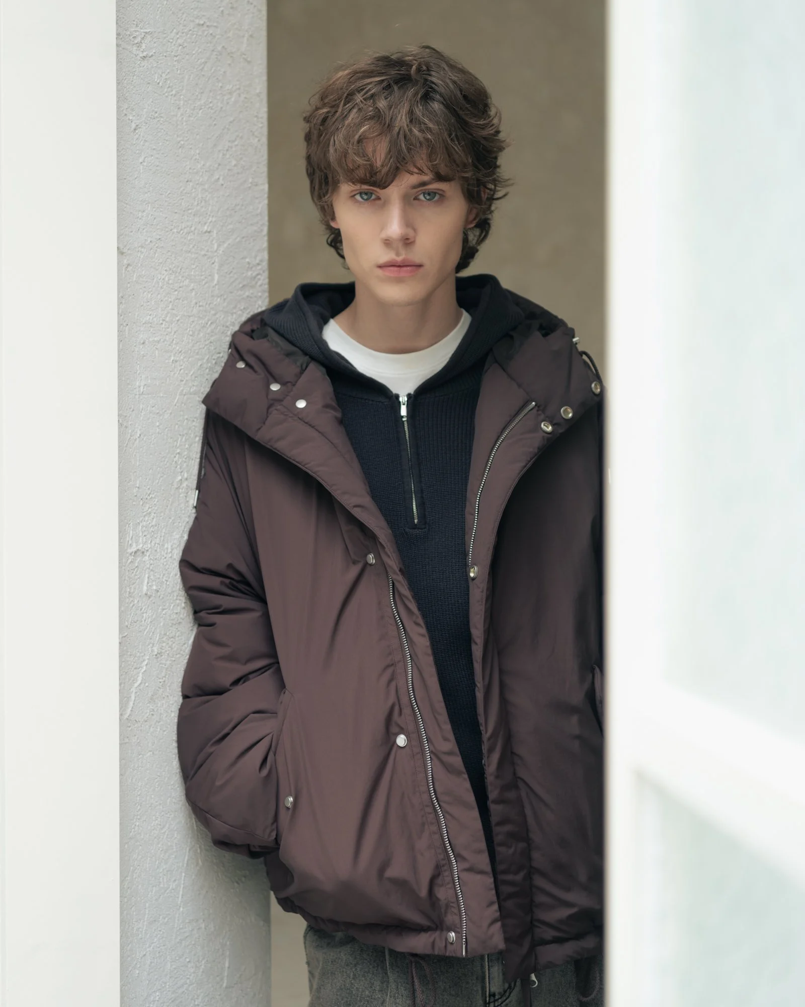 Fashion editorial photograph of a male model in a winter jacket