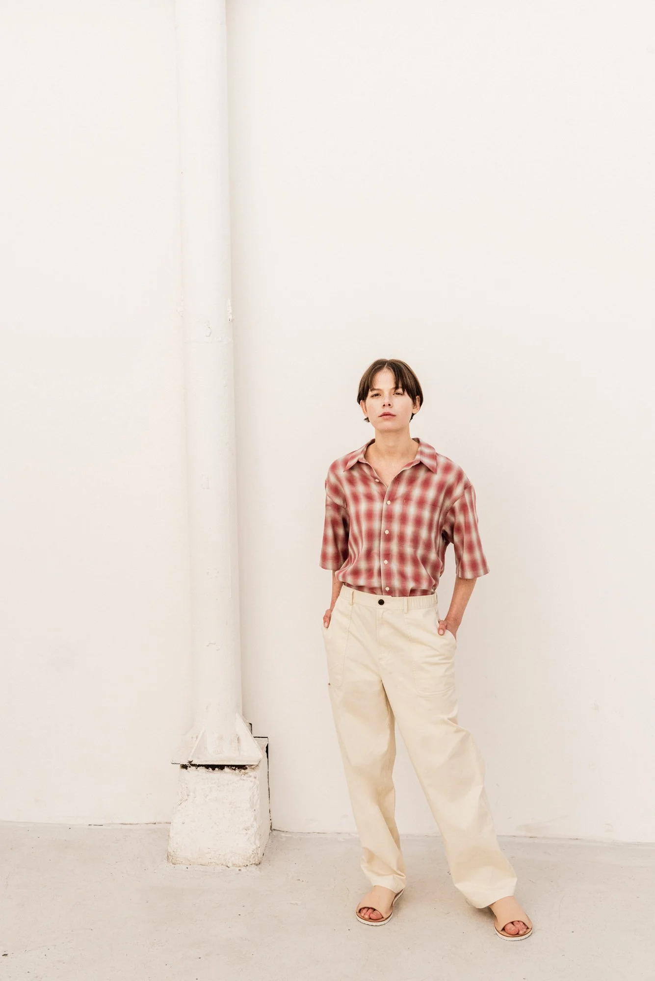 Warm-toned photograph of a female model in casual clothing