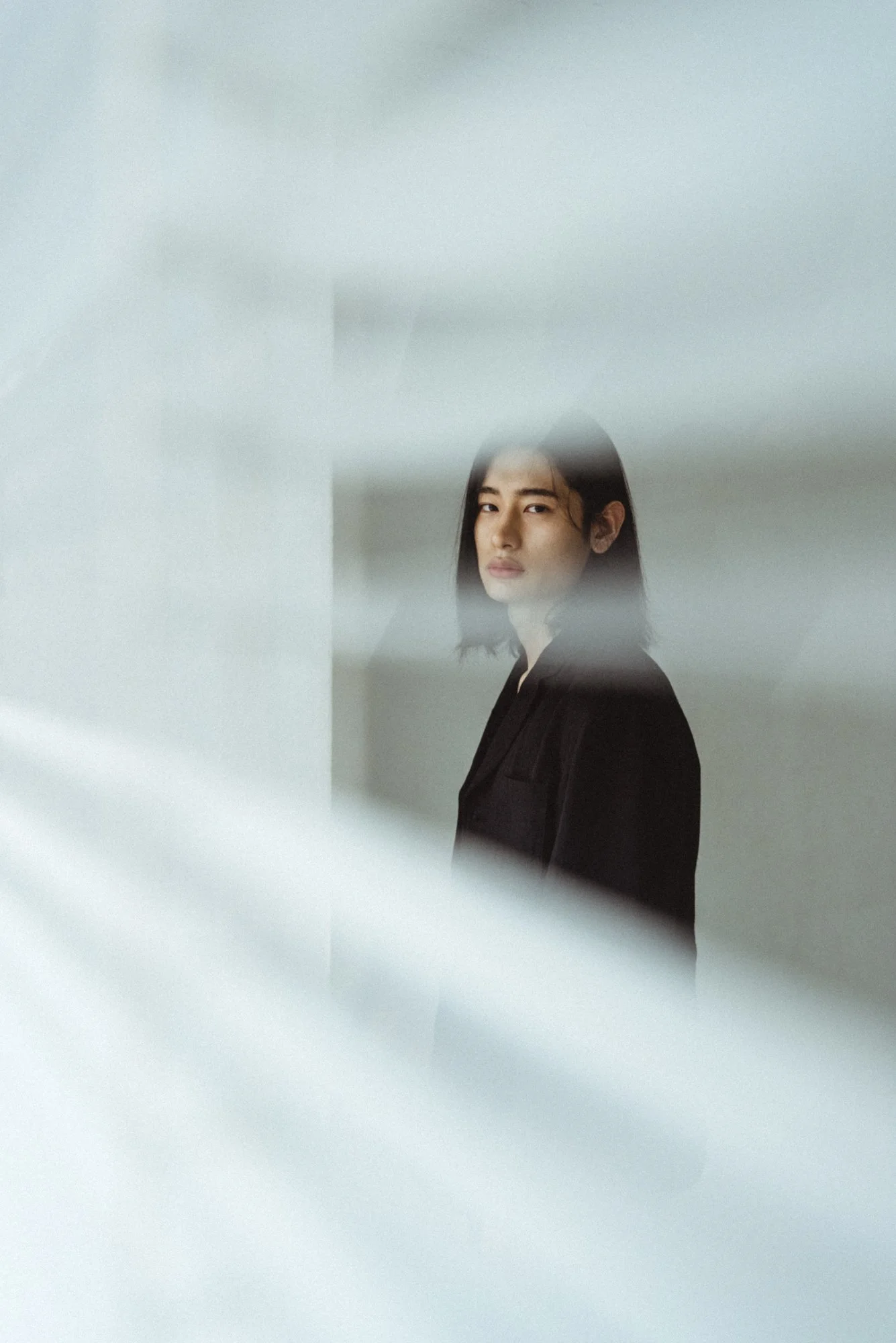 Fashion portrait of a Korean model in a white studio