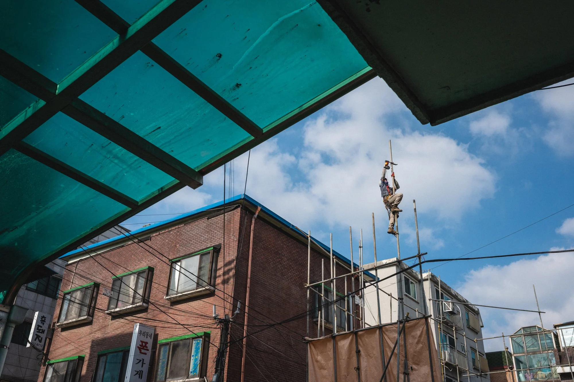 A construction worker climbs a pole in Mangwon, Seoul, South Korea