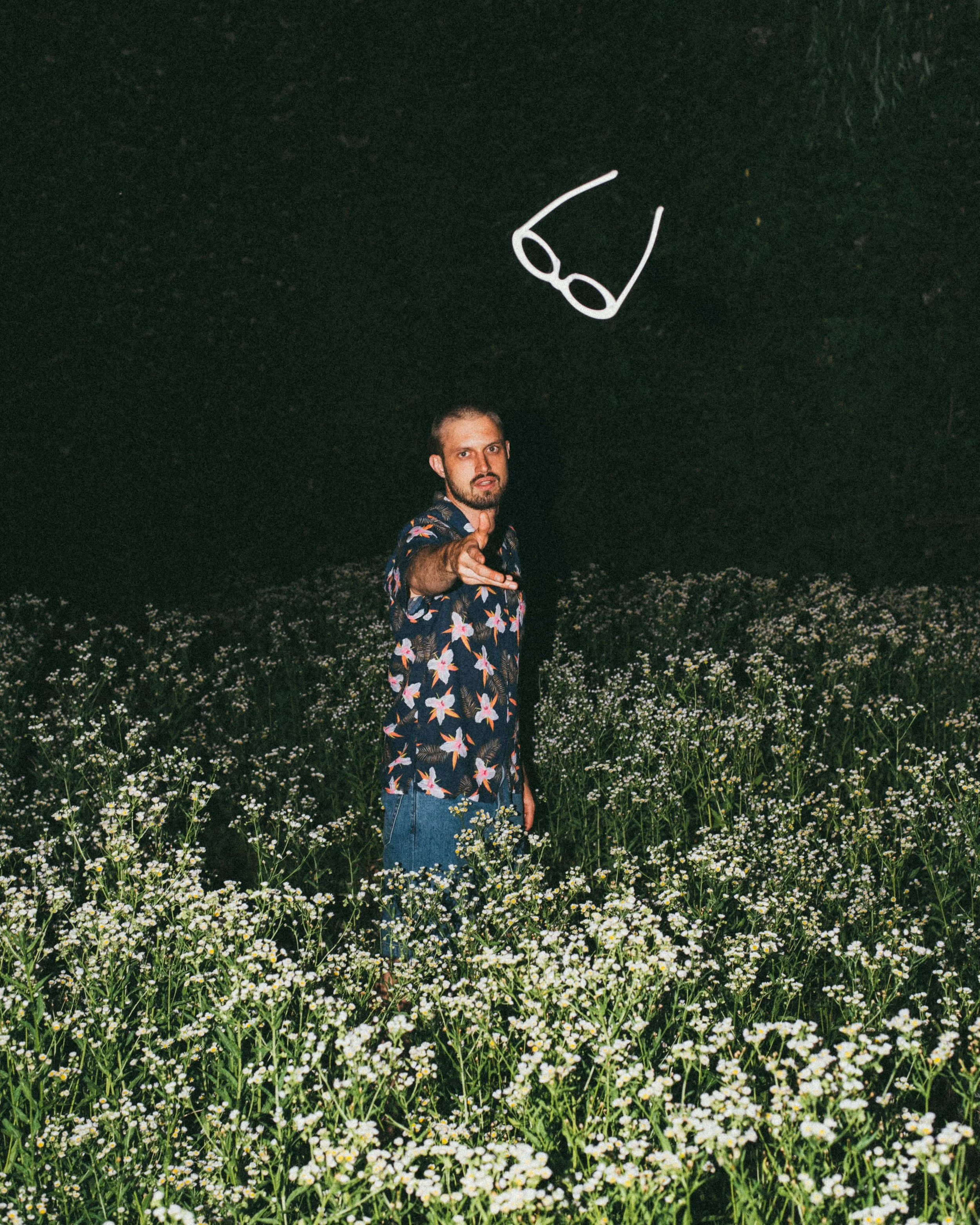 Flash photograph of a model at night throwing white sunglasses in Seoul
